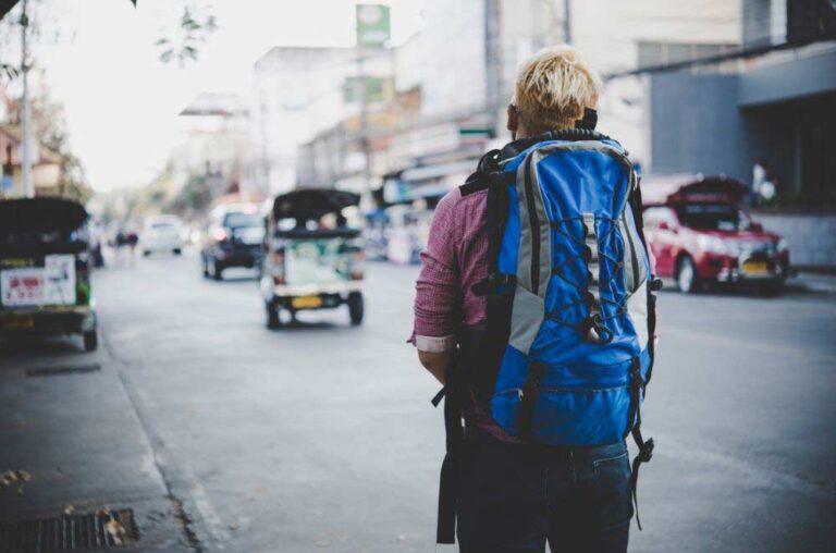 A guy on a road with a travel backpack